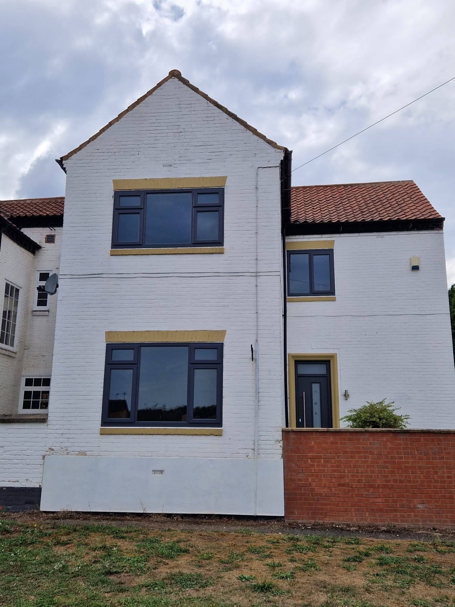 Anthracite grey uPVC casement windows across full house front