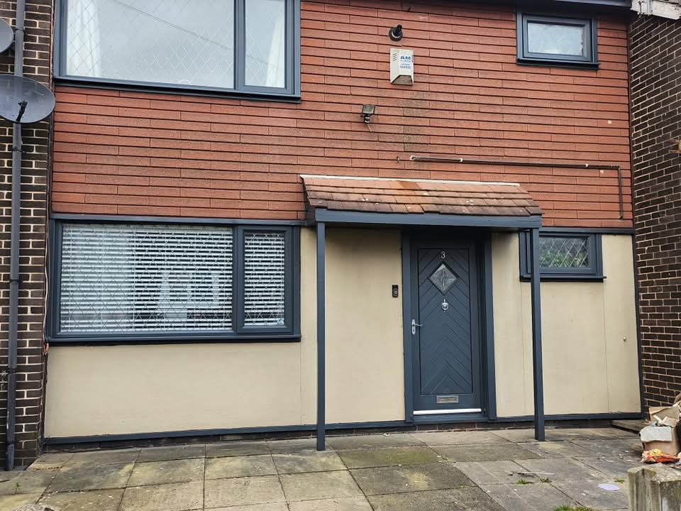 House front with anthracite grey sprayed uPVC windows and composite door